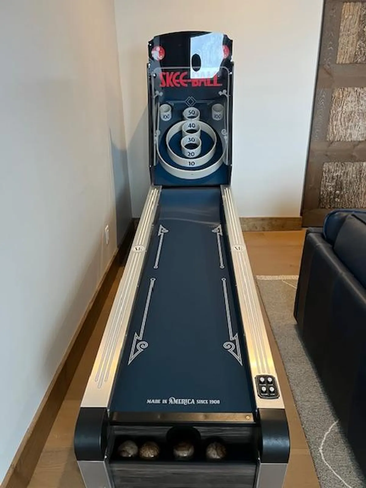 A lively interior image showing a Skee-Ball machine ready for play, capturing the fun, casual side of indoor family entertainment for all ages. The machine is brightly lit and inviting, suggesting lots of friendly competitions and rainy day fun.